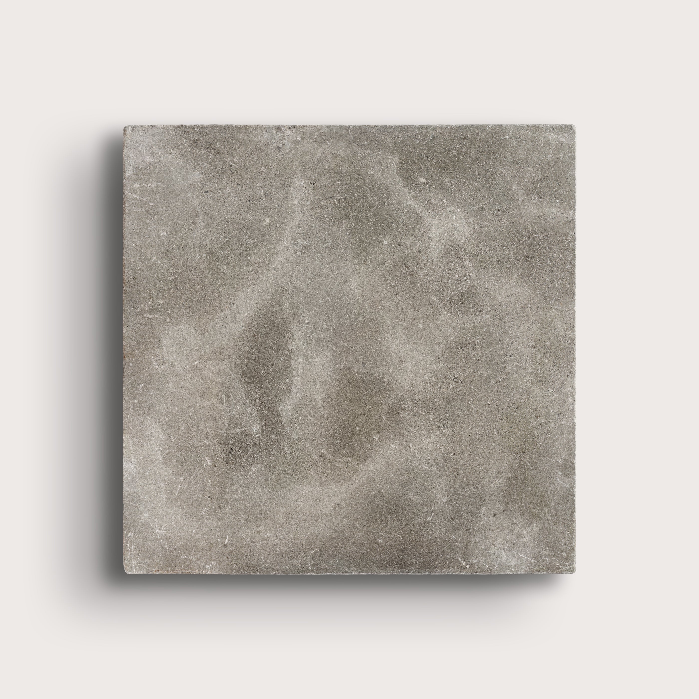 grey square limestone tiles on a light grey background