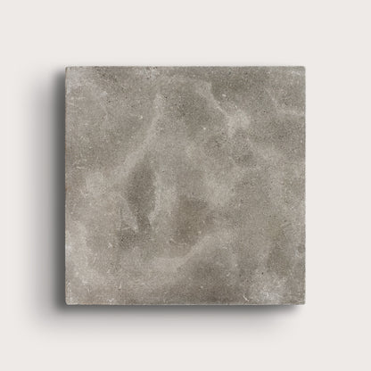 grey square limestone tiles on a light grey background
