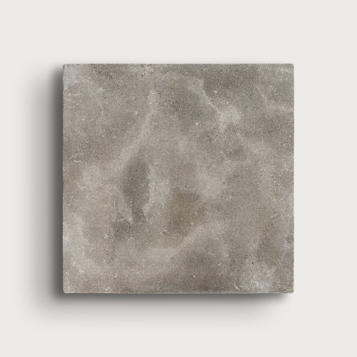grey square limestone tiles on a light grey background