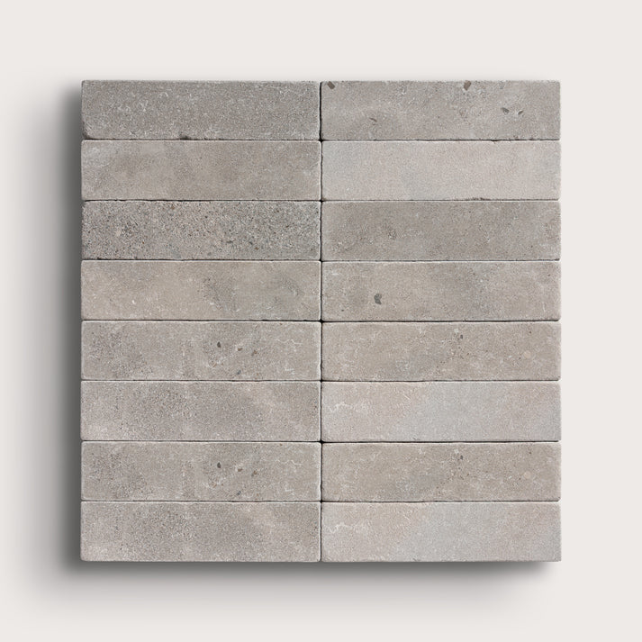 grey rectangle limestone tile in a grid pattern on light grey background
