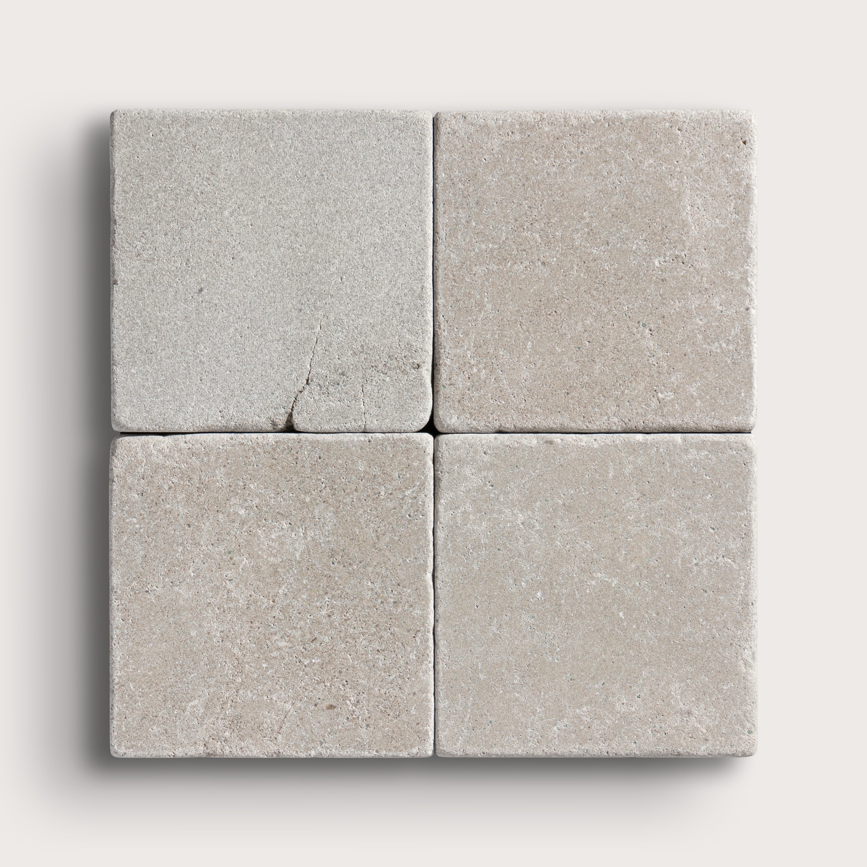 grey limestone square tile in a grid pattern on light grey background