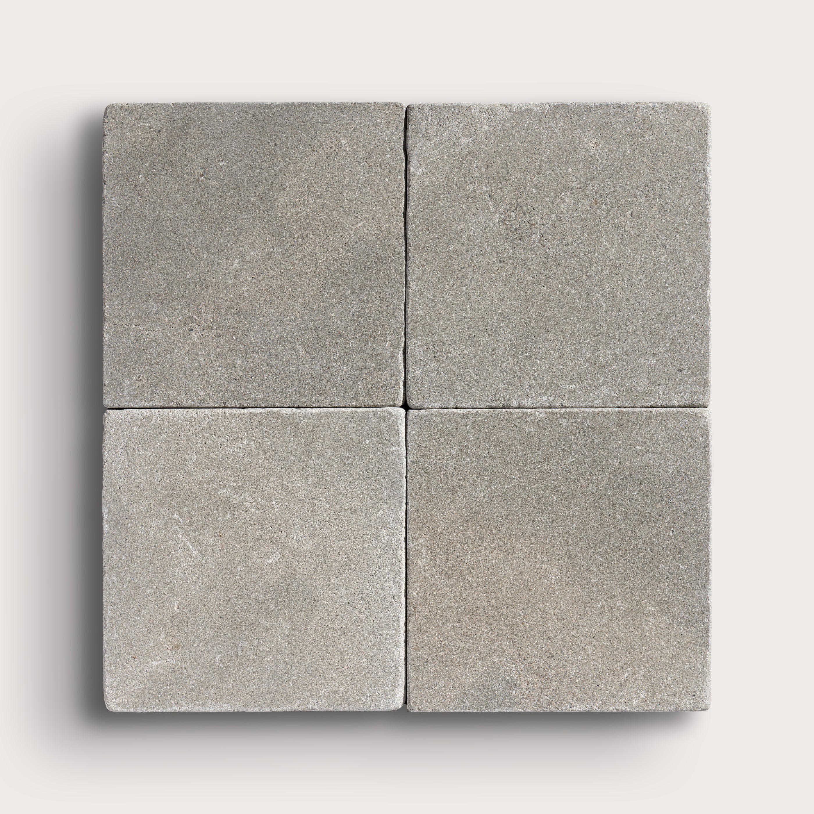 grey limestone square tile in a grid pattern on light grey background