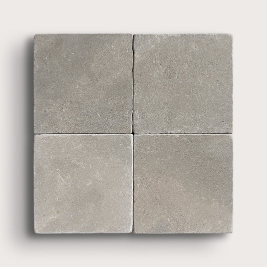 grey limestone square tile in a grid pattern on light grey background