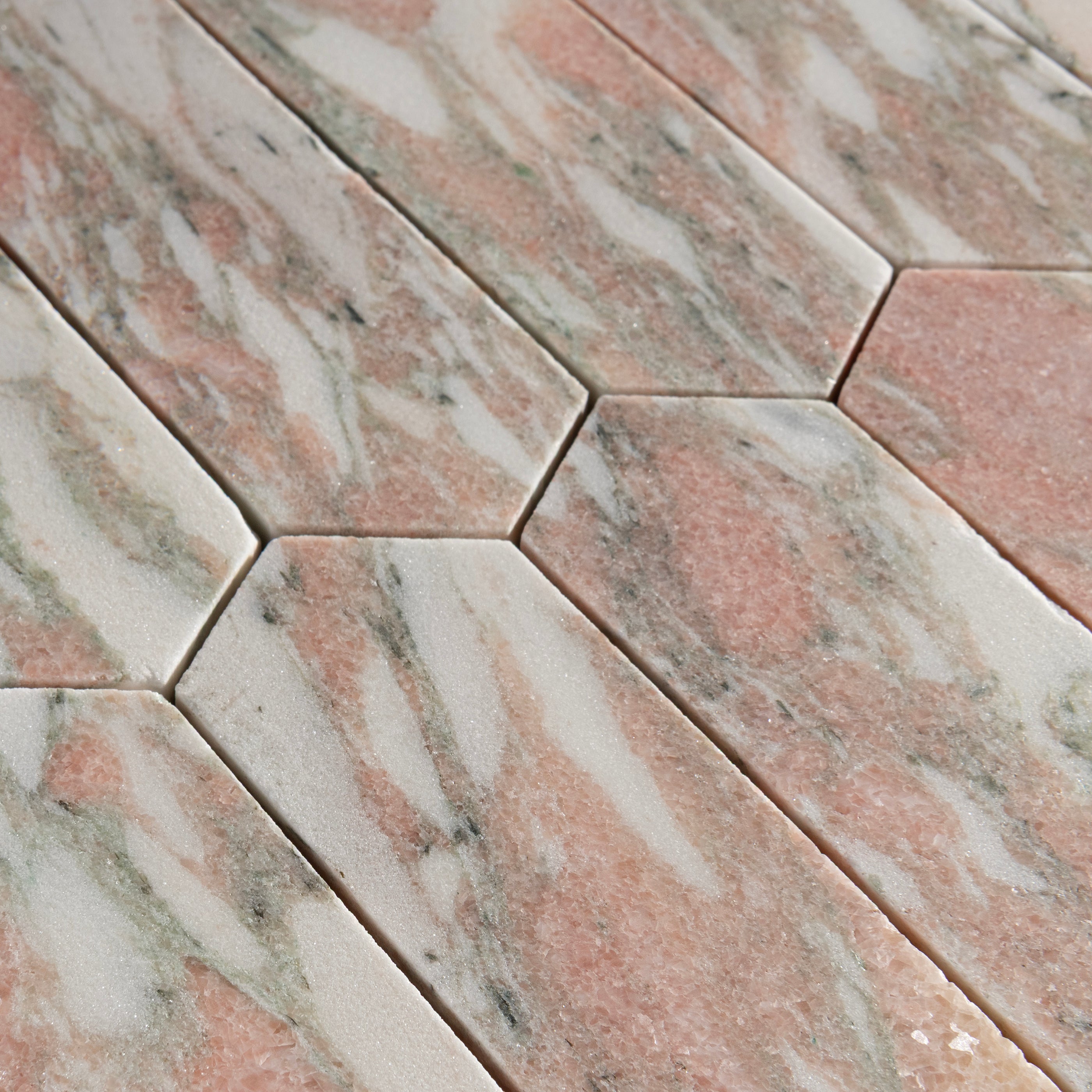 close up of Hexagonal tiles with a pink and gray marbled pattern