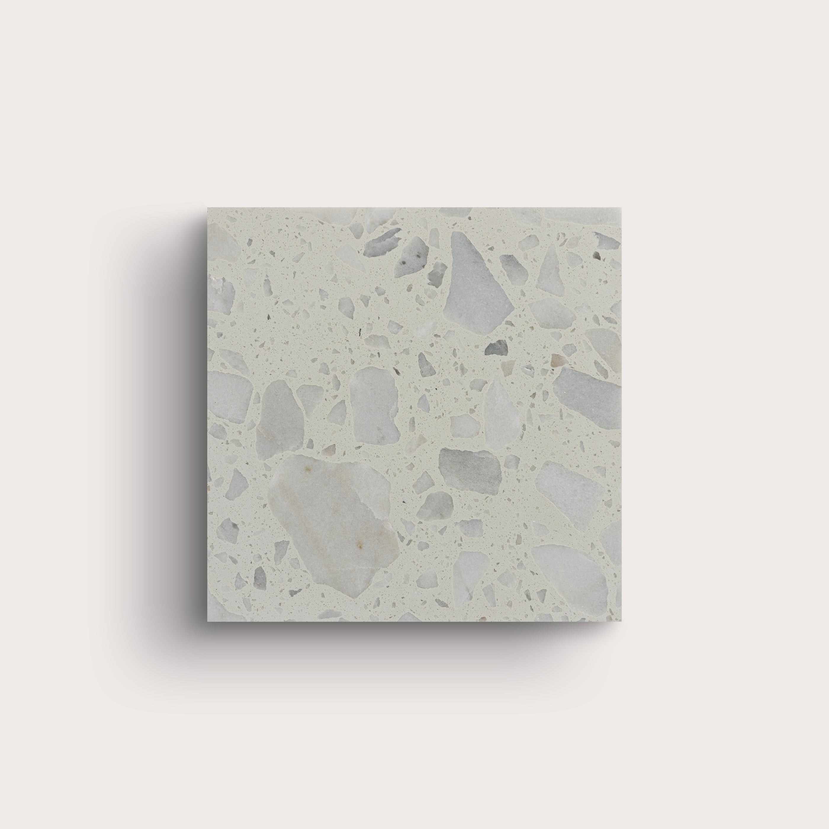 Square concrete tile with a terrazzo pattern on a light gray background