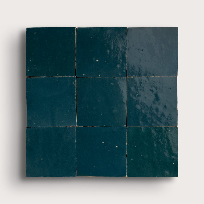 Nine dark blue tiles arranged in a 3x3 grid on a white background