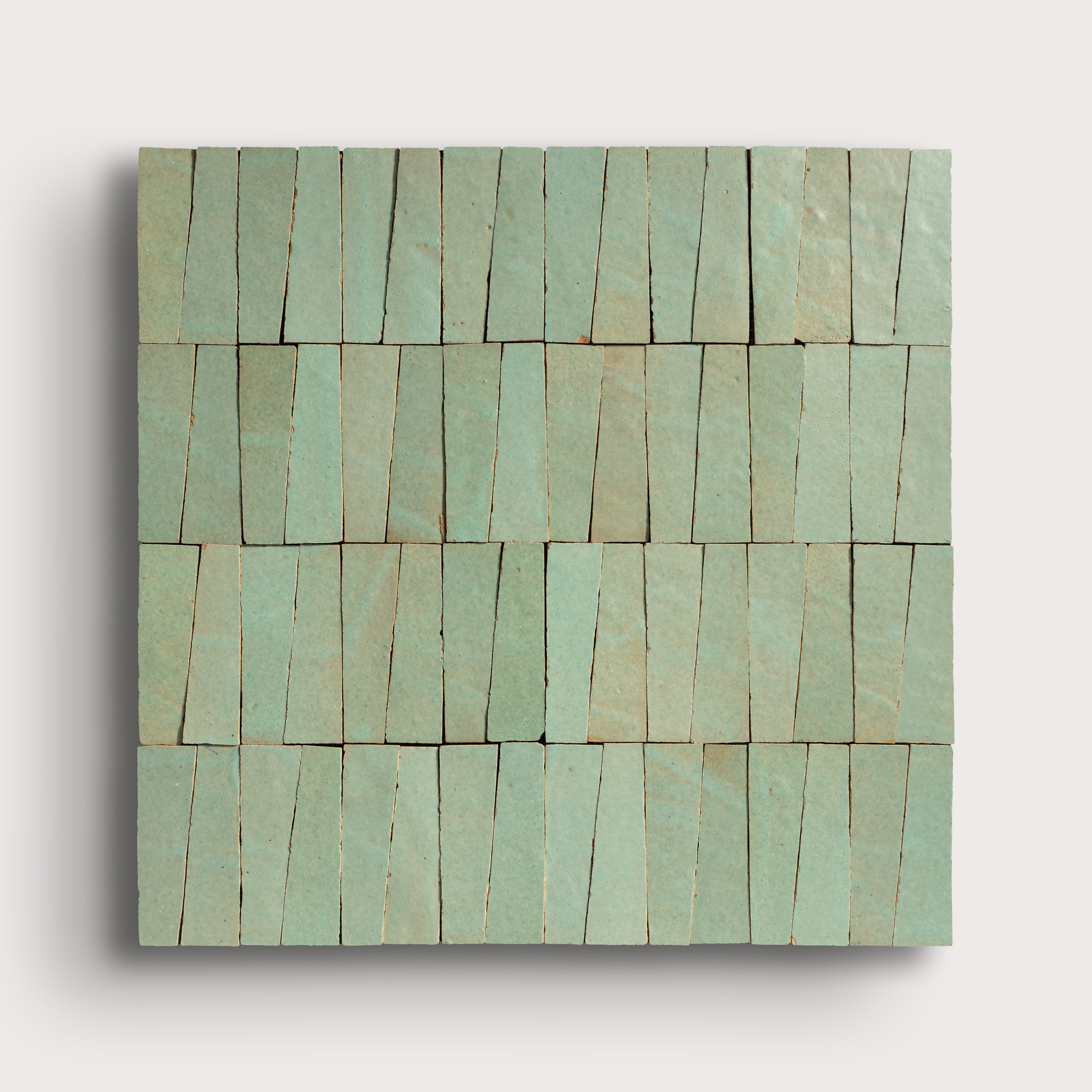 Rectangular green tile with a pattern of horizontal lines on a light gray background
