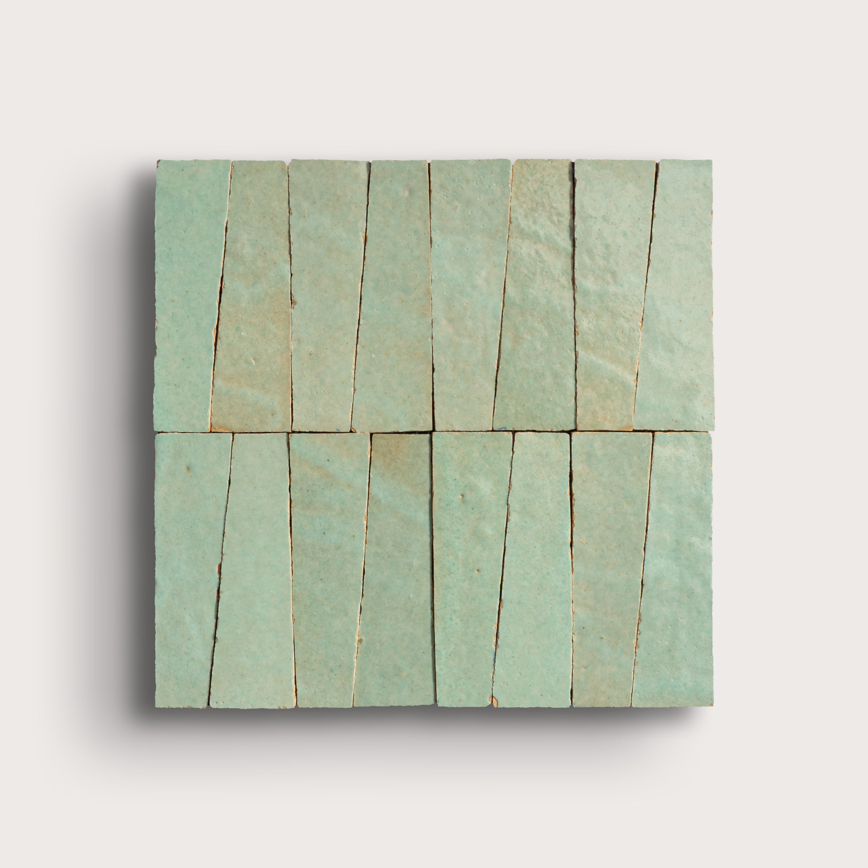 Rectangular green tile with a pattern of horizontal lines on a light gray background