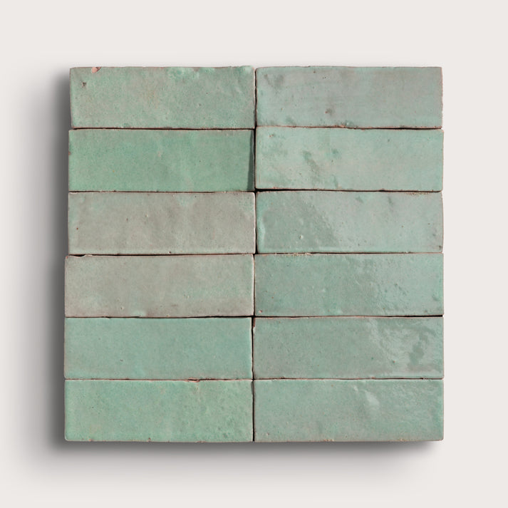 Set of green zellige tiles on a white background