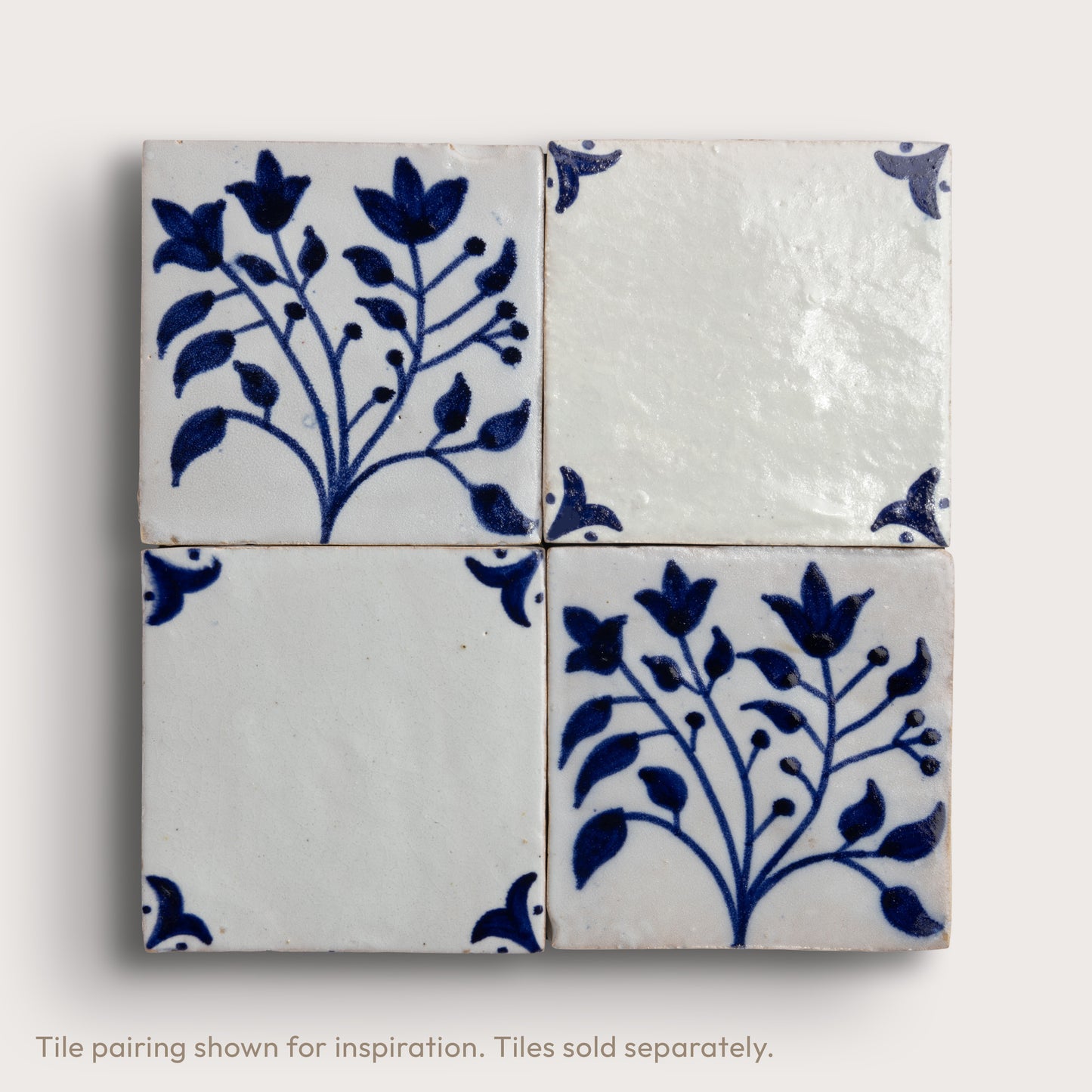 Four square zellige tiles arranged in a 2x2 grid, featuring a classic Dutch blue-and-white floral pattern on an off-white background.