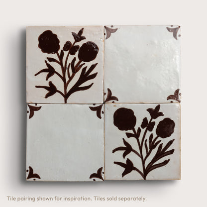 Four square zellige tiles arranged in a 2x2 grid, featuring a dark brown floral motif on an off-white background, with decorative corner accents.