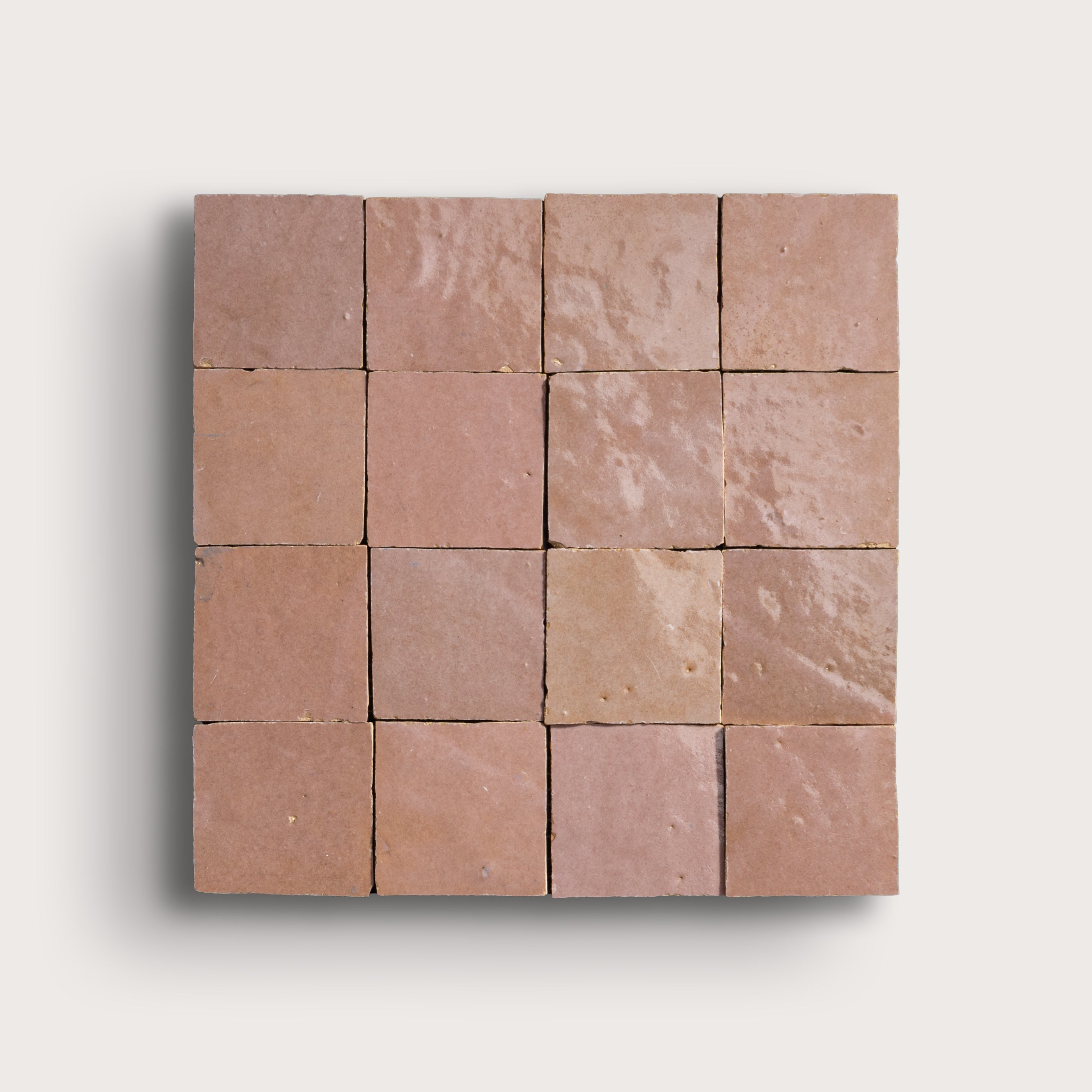 Square arrangement of blush zellige tiles on a light gray background