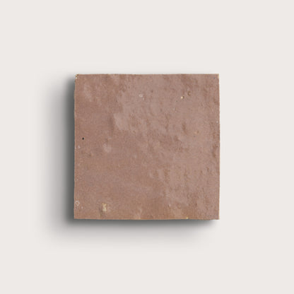 Square blush zellige tile on a light gray background