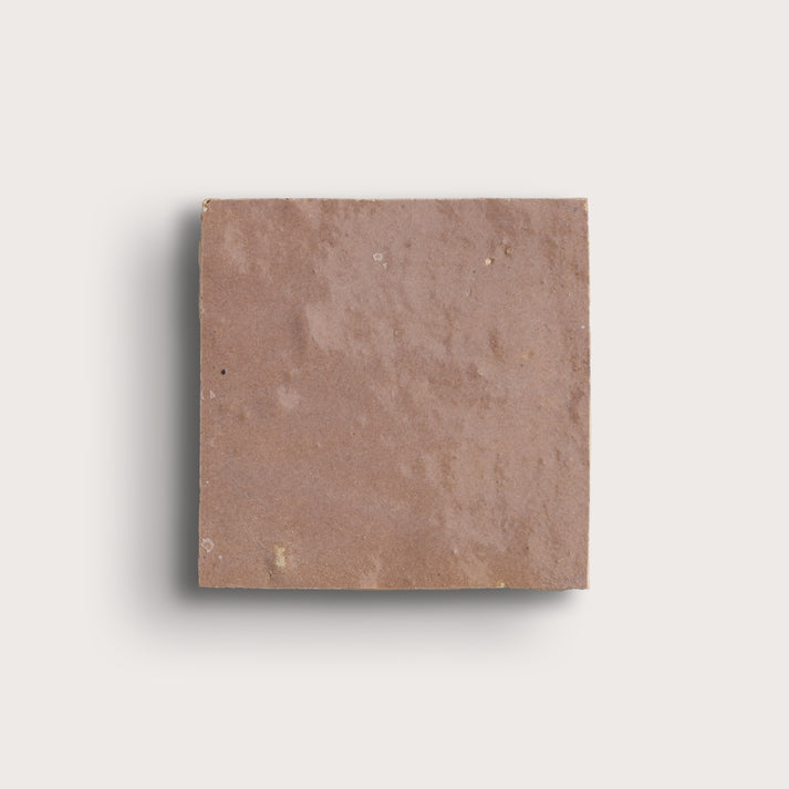 Square blush zellige tile on a light gray background
