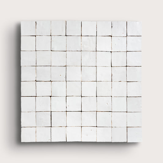 Grid of small white zellige tiles on a light gray background