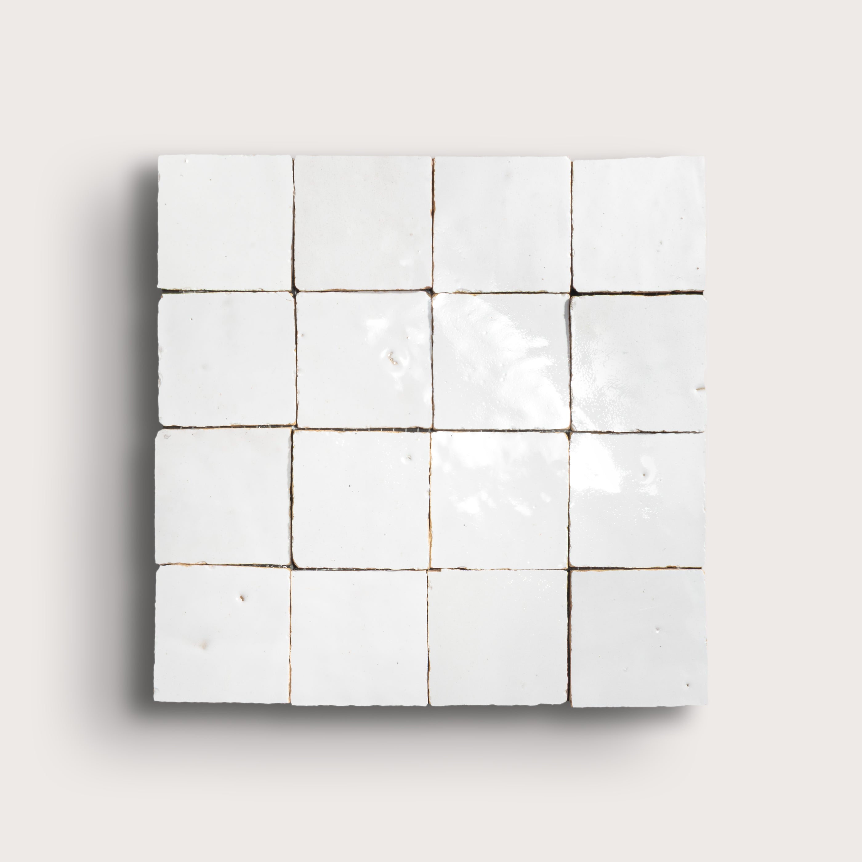 Grid of small white zellige tiles on a light gray background