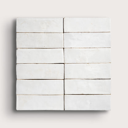 Set of white zellige tiles arranged in a grid pattern on a light gray background
