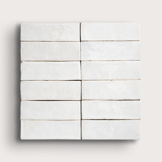 Set of white zellige tiles arranged in a grid pattern on a light gray background