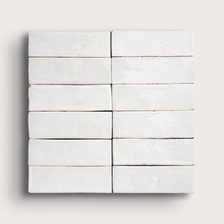 Set of white zellige tiles arranged in a grid pattern on a light gray background