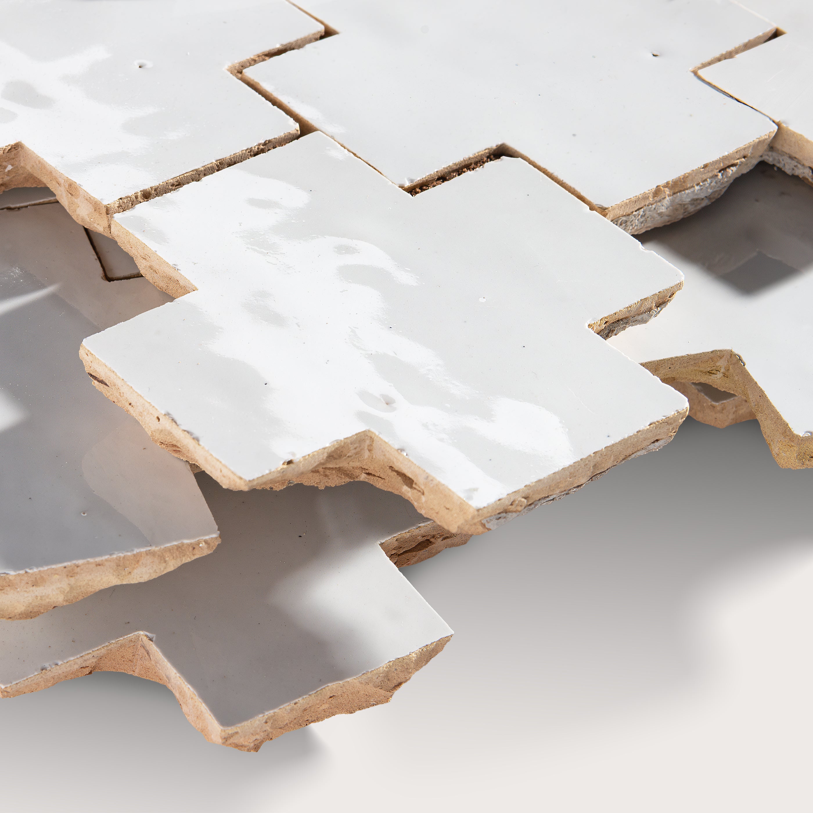 close up angle of white zellige tile in cross pattern