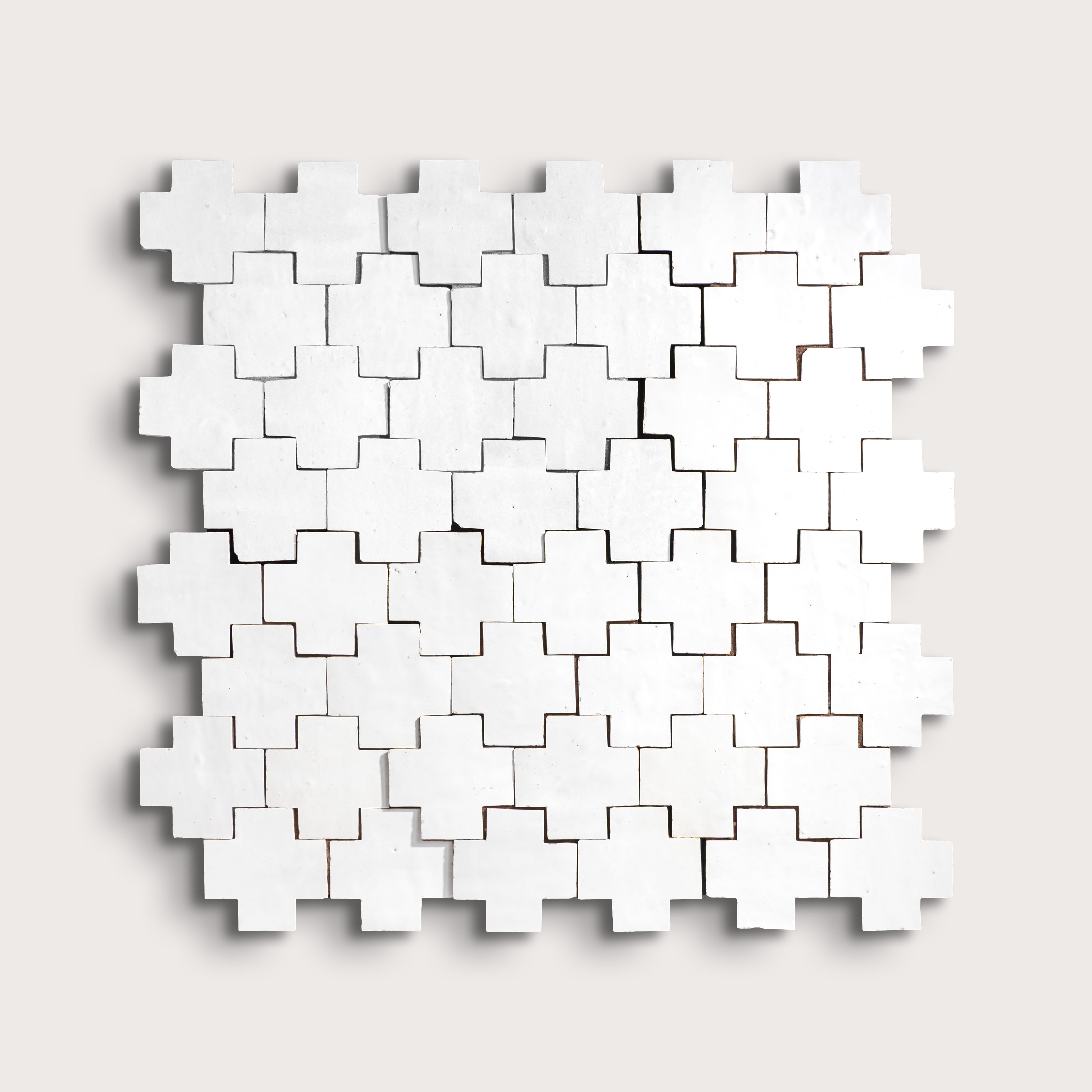 white zellige cross geometric design on a light gray background