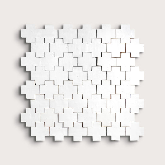 white zellige cross geometric design on a light gray background