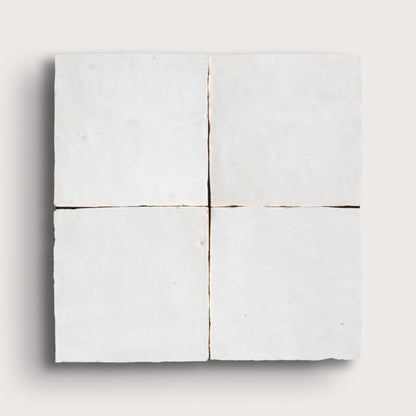 White zellige tile with a grid pattern on a white background