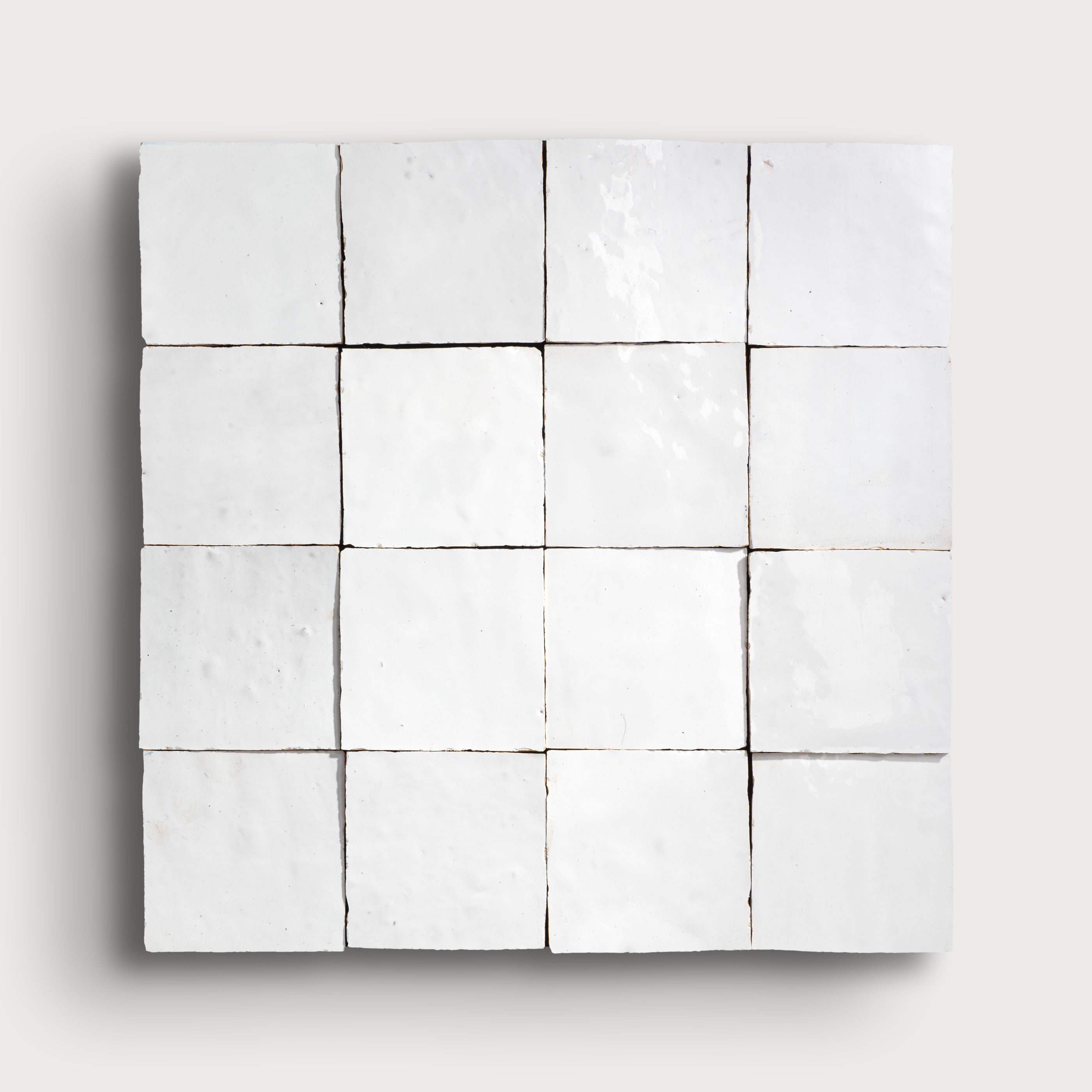 Square tile with a grid pattern on a light gray background