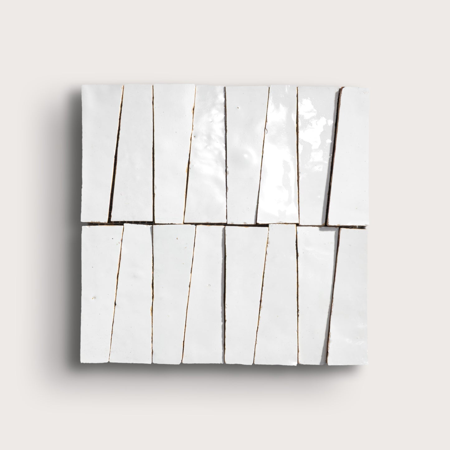 Set of ceramic tiles with white trapezoid shape on a light gray background