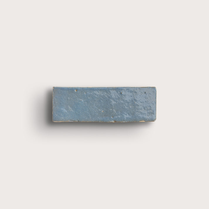 Rectangular blue stone zellige tile on a light gray background