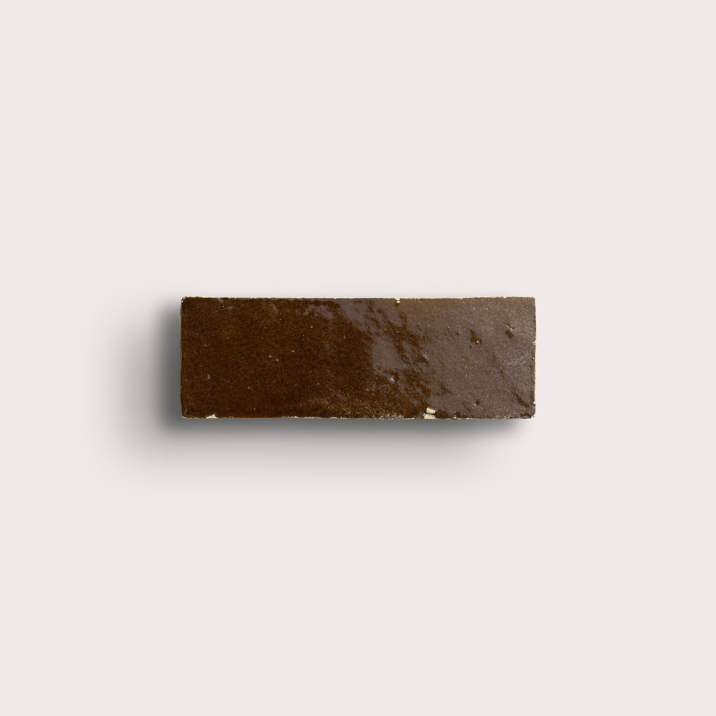 brown rectangle zellige tile on a light grey background