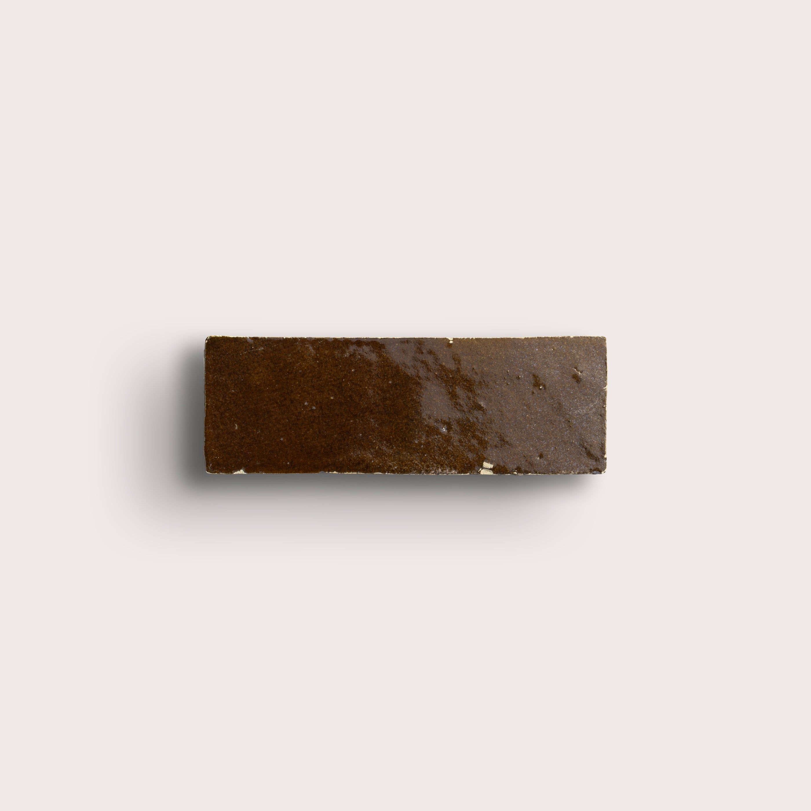 brown rectangle zellige tile on a light grey background