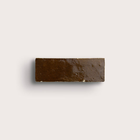 brown rectangle zellige tile on a light grey background