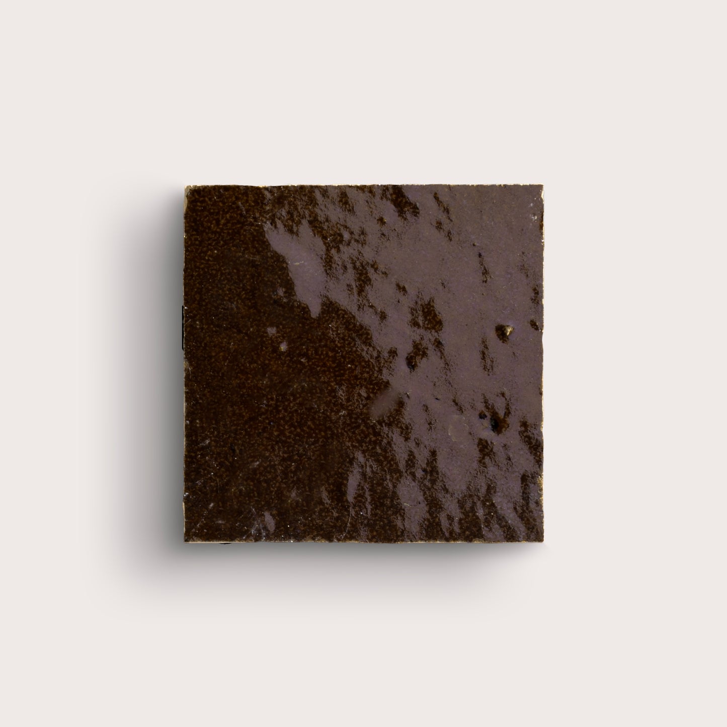 brown square zellige tile on a light grey background
