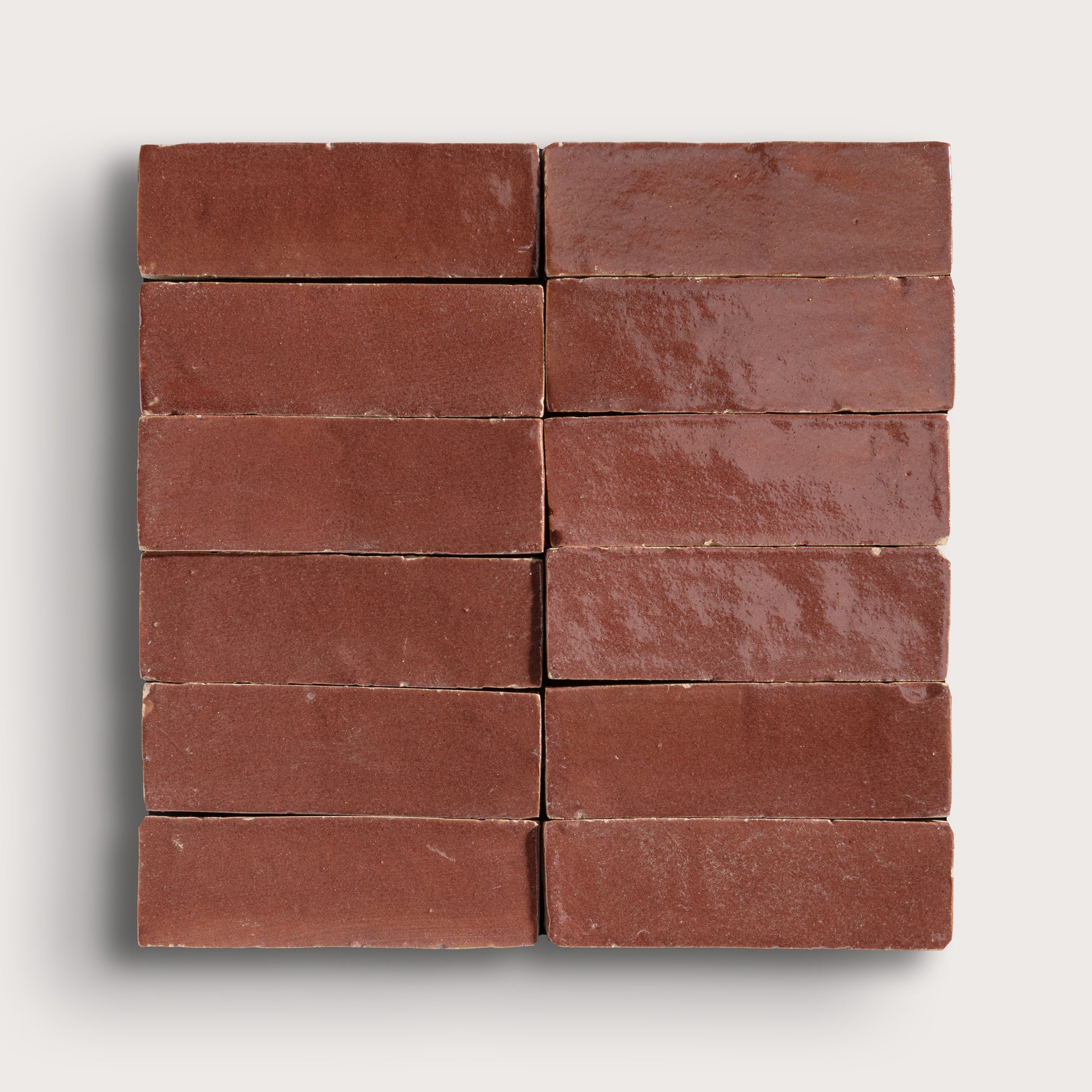 Nine red zellige tiles arranged in a 3x3 grid on a white background