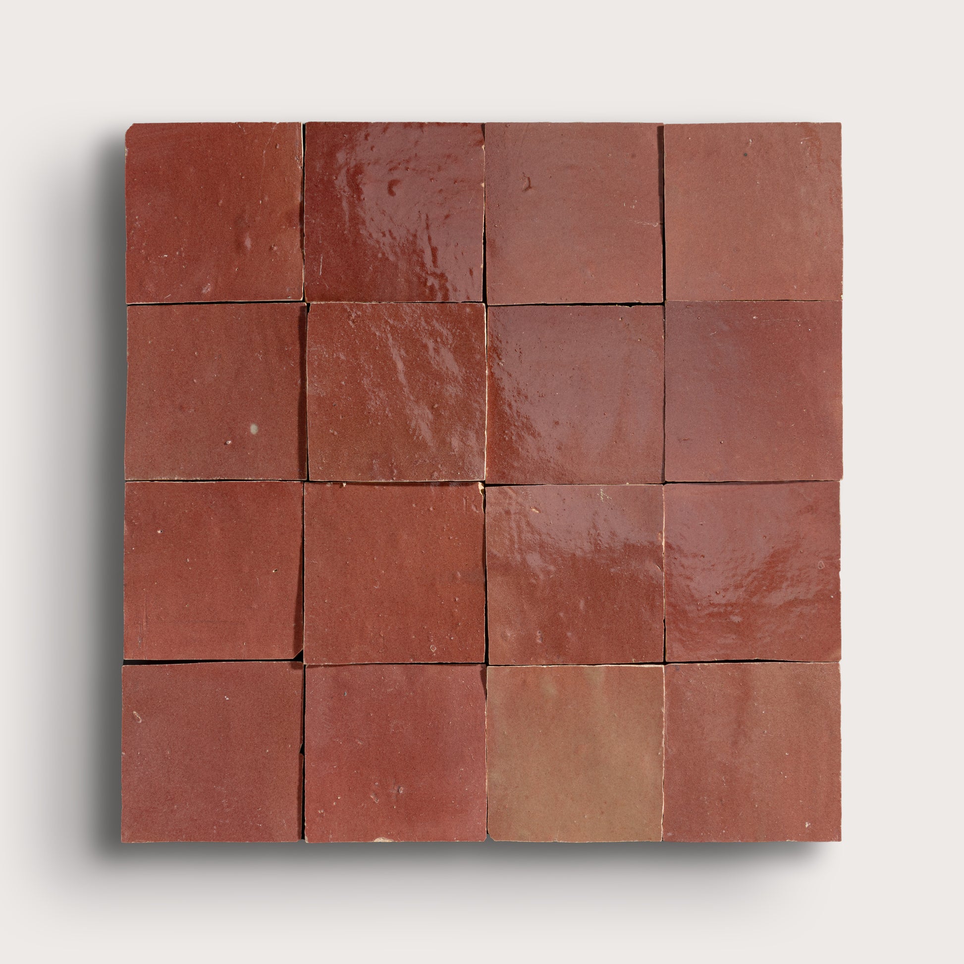 Square arrangement of red tiles on a white background