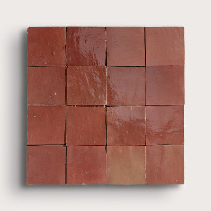 Square arrangement of red tiles on a white background