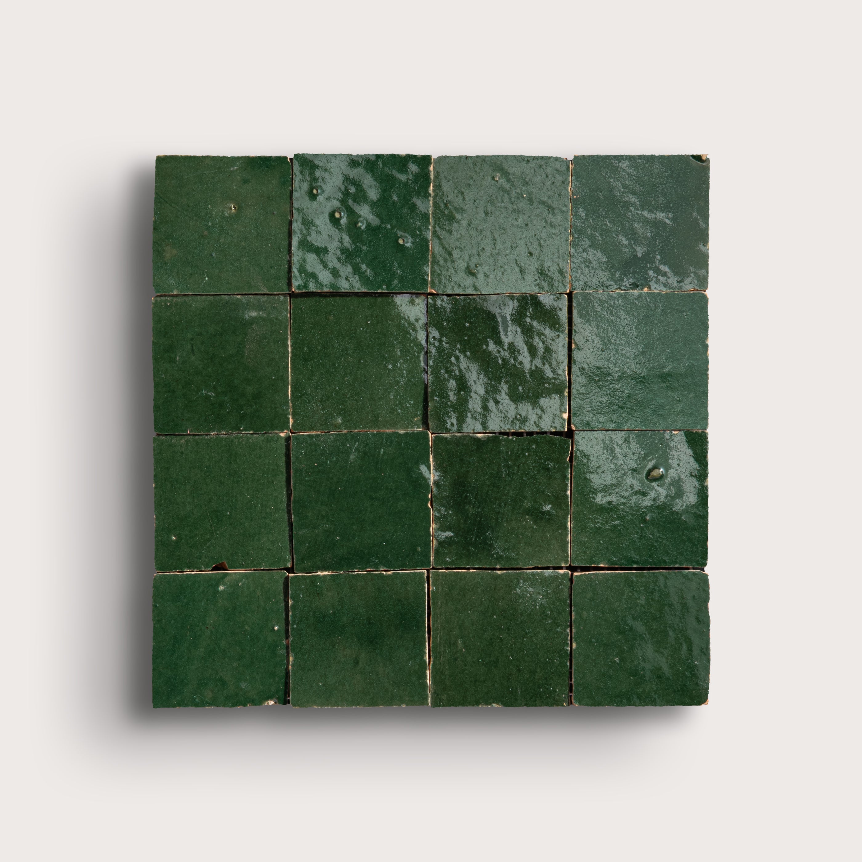 Green square tiles arranged in a grid pattern on a light gray background