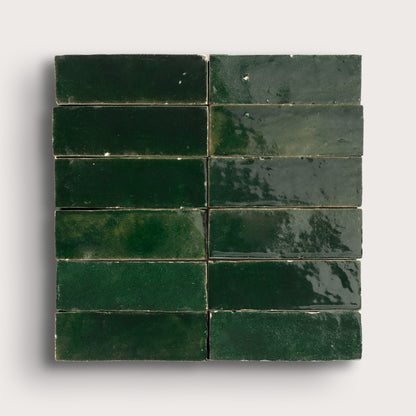 Green zellige tiles arranged in a grid pattern on a white background