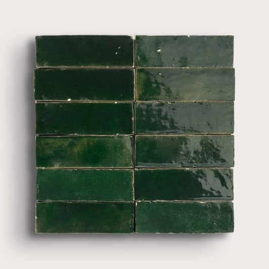 Green zellige tiles arranged in a grid pattern on a white background