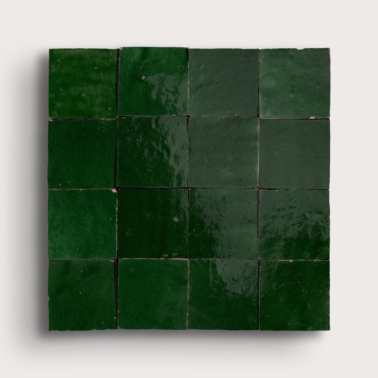 Square arrangement of green zellige tiles on a white background