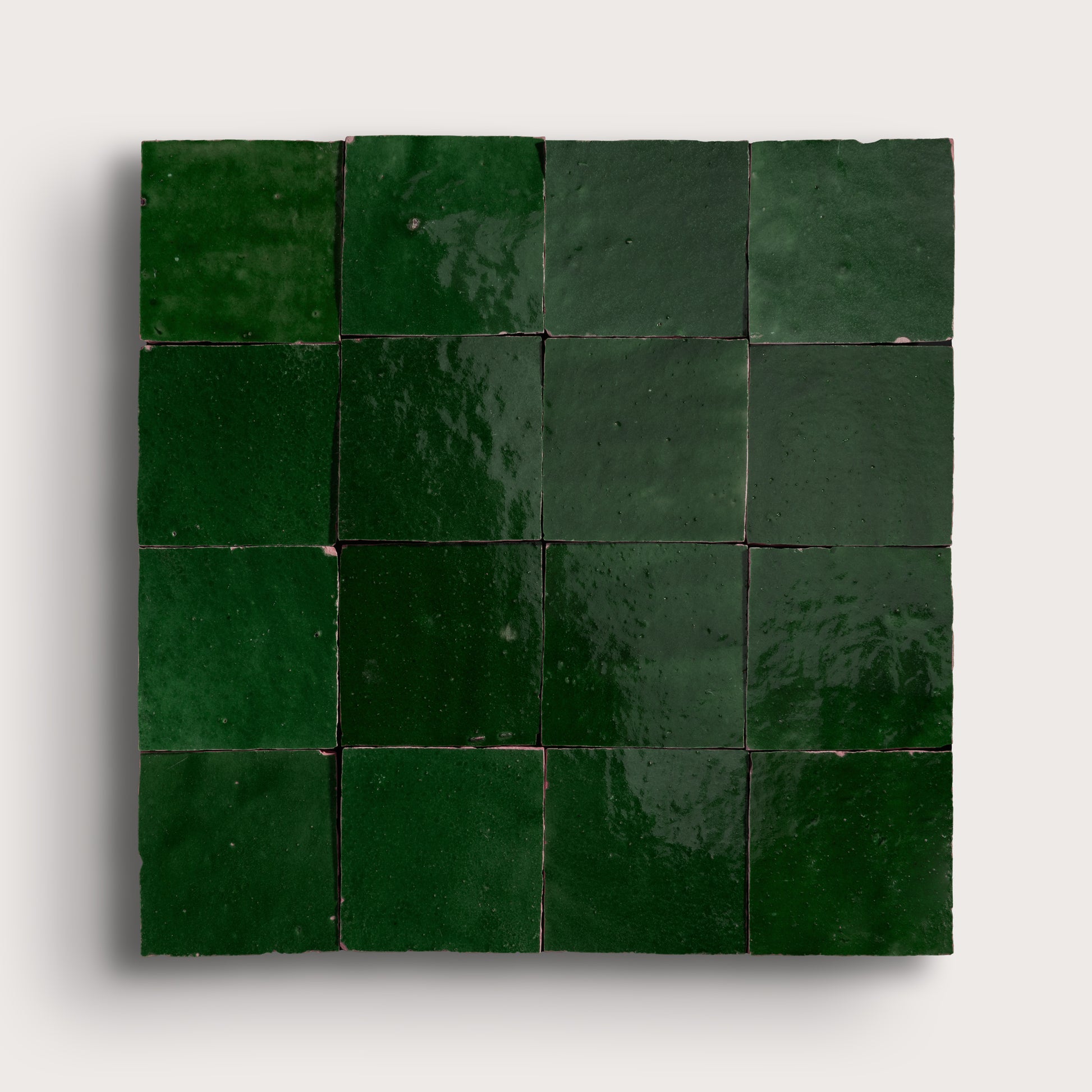 Square arrangement of green zellige tiles on a white background