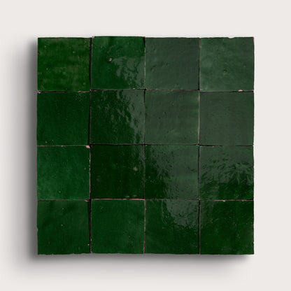 Square arrangement of green zellige tiles on a white background