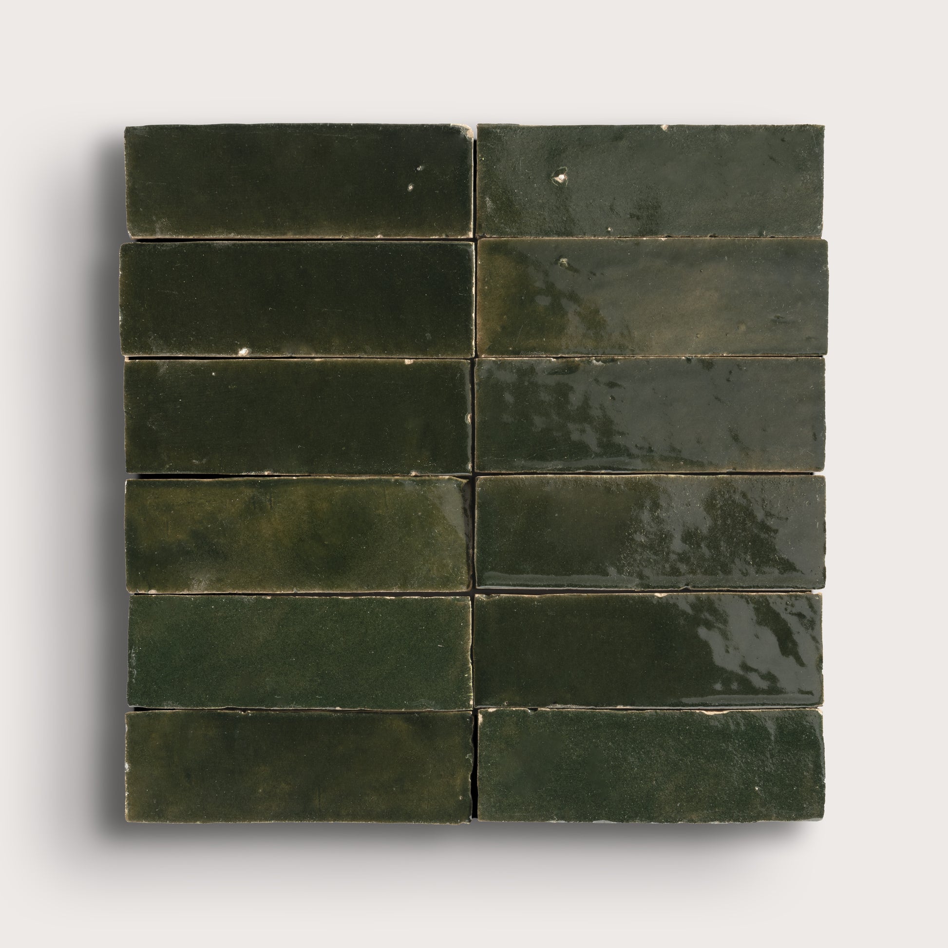 Green zellige tiles arranged in a grid pattern on a white background