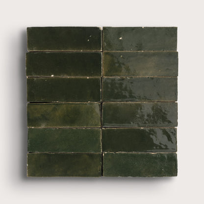 Green zellige tiles arranged in a grid pattern on a white background