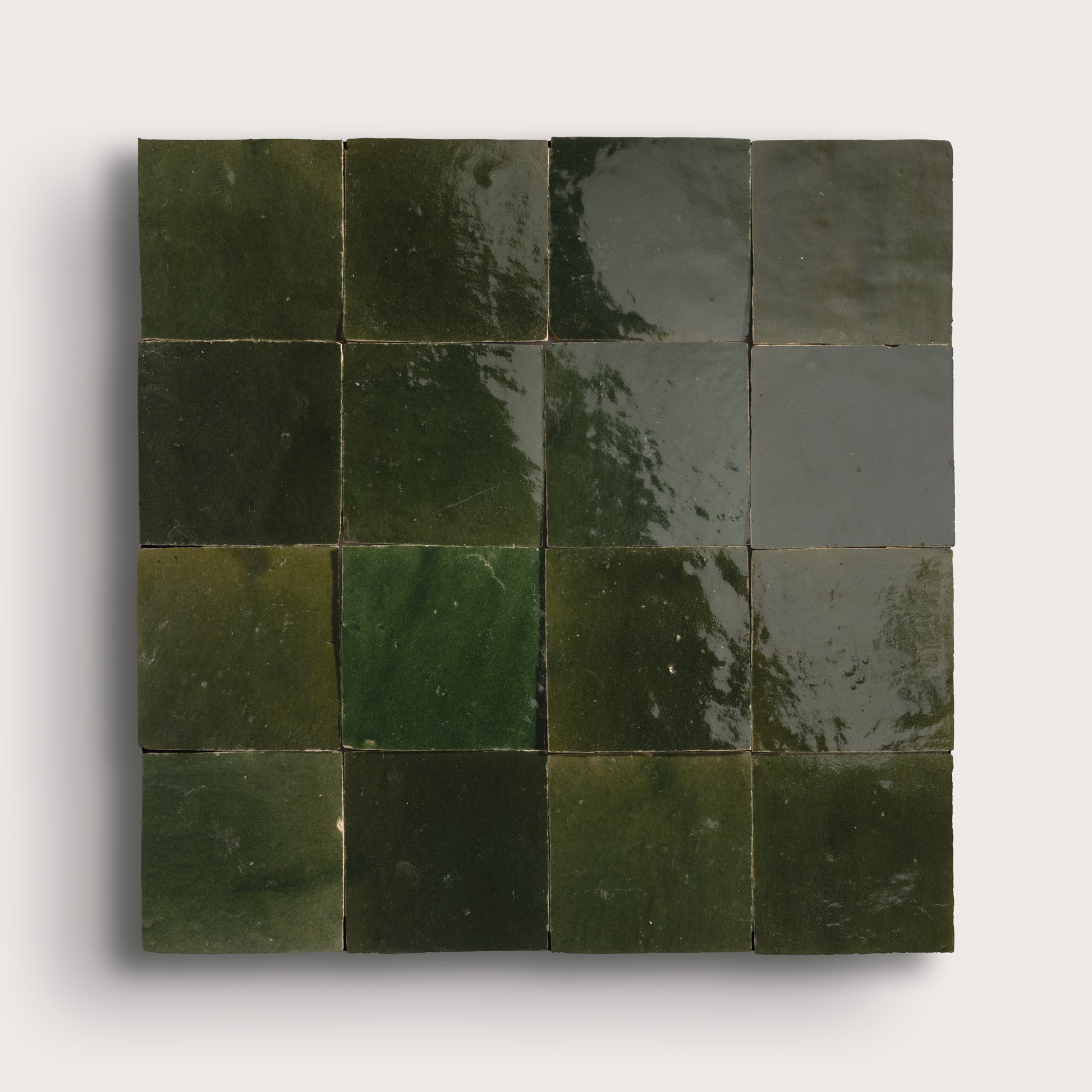 Square arrangement of green tiles on a white background
