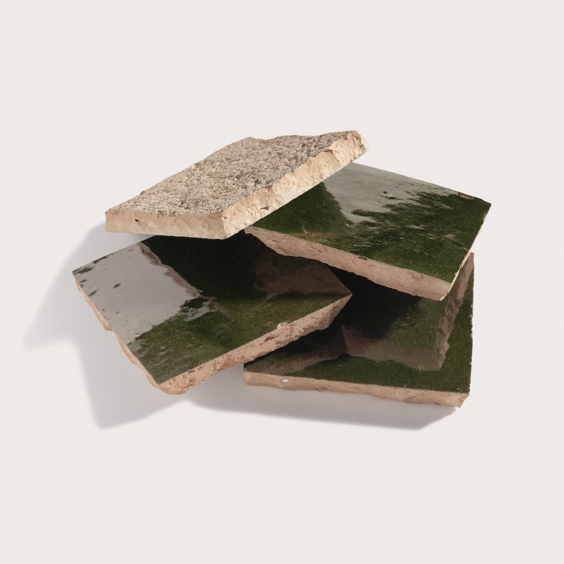 Set of zellige tiles with greenish surface on a white background