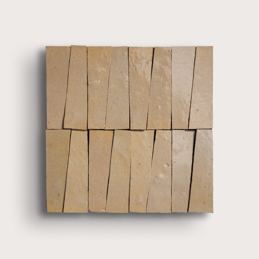 Beige stone tiles arranged in a geometric pattern on a white background