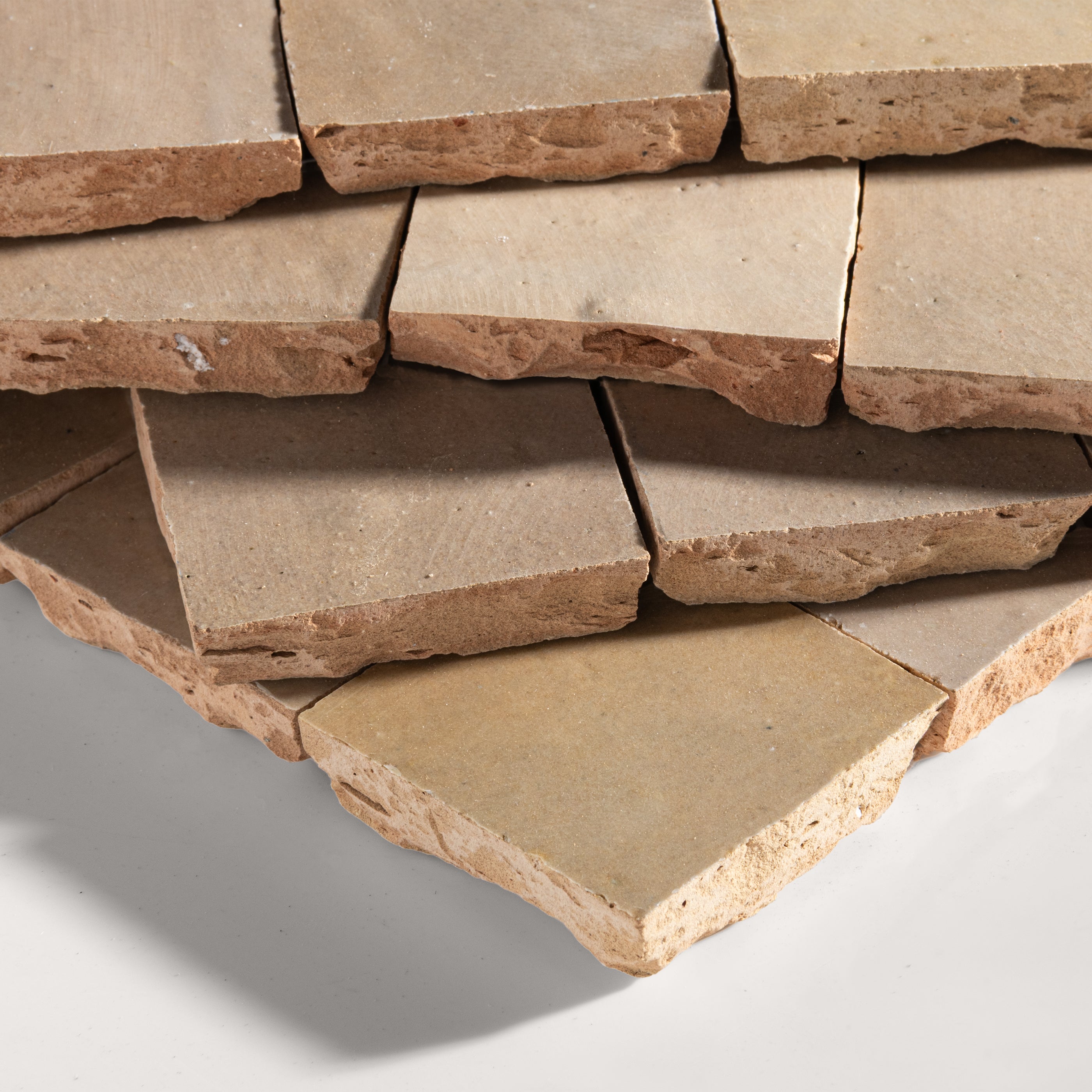 Stack of stone tiles on a light gray background