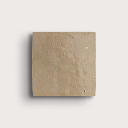 Square beige zellige tile on a light gray background